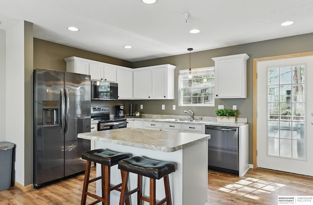 6031 N 167th Ct, Omaha, NE 68116 - kitchen with stainless steel appliances, a sink, white cabinetry, light countertops, and recessed lighting
