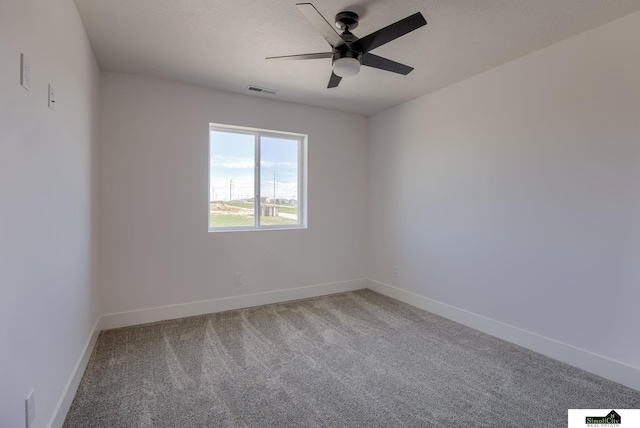 empty room with a ceiling fan, carpet flooring, and baseboards