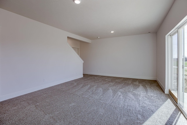 spare room featuring carpet, baseboards, and recessed lighting