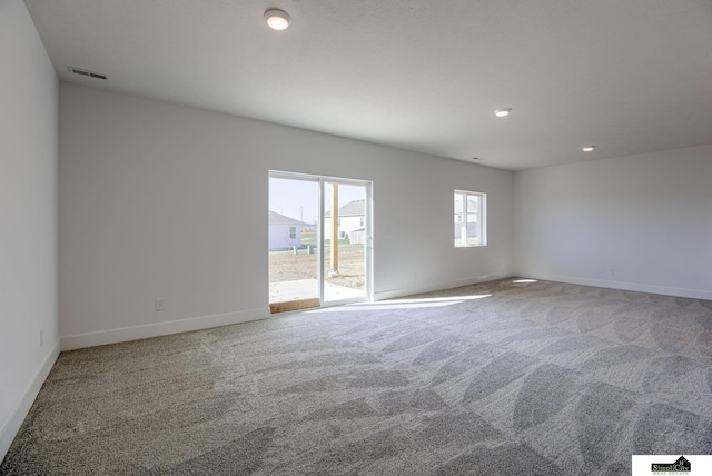 unfurnished room with carpet floors, baseboards, and recessed lighting