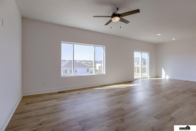 spare room with ceiling fan, light wood finished floors, baseboards, and recessed lighting