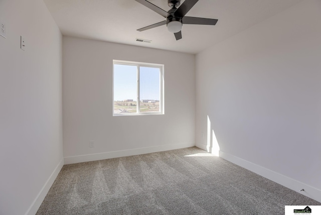 carpeted empty room with ceiling fan and baseboards