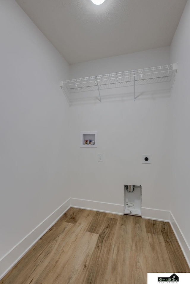 laundry room with electric dryer hookup, light wood-type flooring, washer hookup, and baseboards