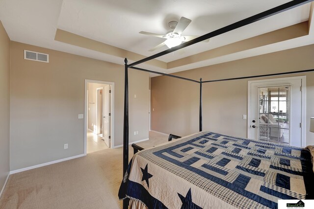 8420 Augusta Dr, Lincoln, NE 68526 - bedroom featuring baseboards, light carpet, ceiling fan, and a tray ceiling