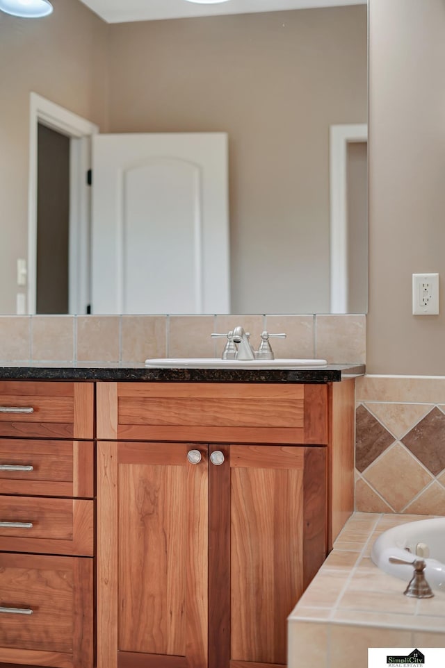 8420 Augusta Dr, Lincoln, NE 68526 - bathroom featuring vanity and a tub to relax in