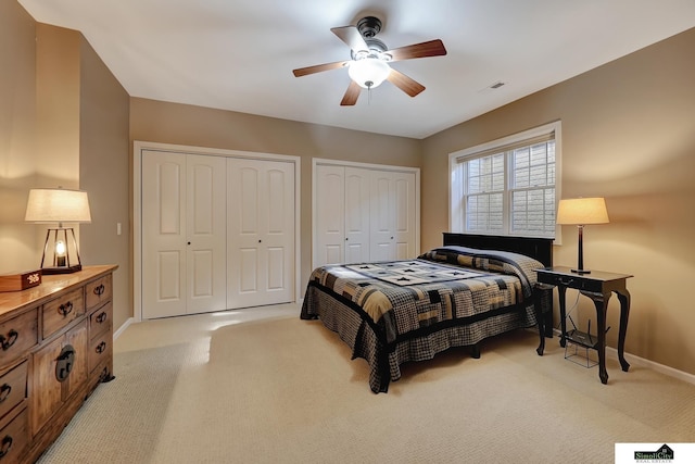 8420 Augusta Dr, Lincoln, NE 68526 - bedroom with multiple closets, light carpet, baseboards, and a ceiling fan
