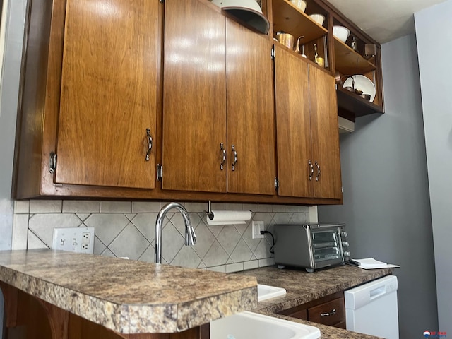 803 6th St, Fairbury, NE 68352 - kitchen with tasteful backsplash, dishwasher, open shelves, and brown cabinetry
