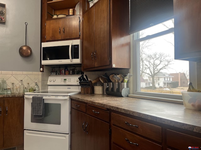 803 6th St, Fairbury, NE 68352 - kitchen featuring white appliances, tasteful backsplash, and dark countertops