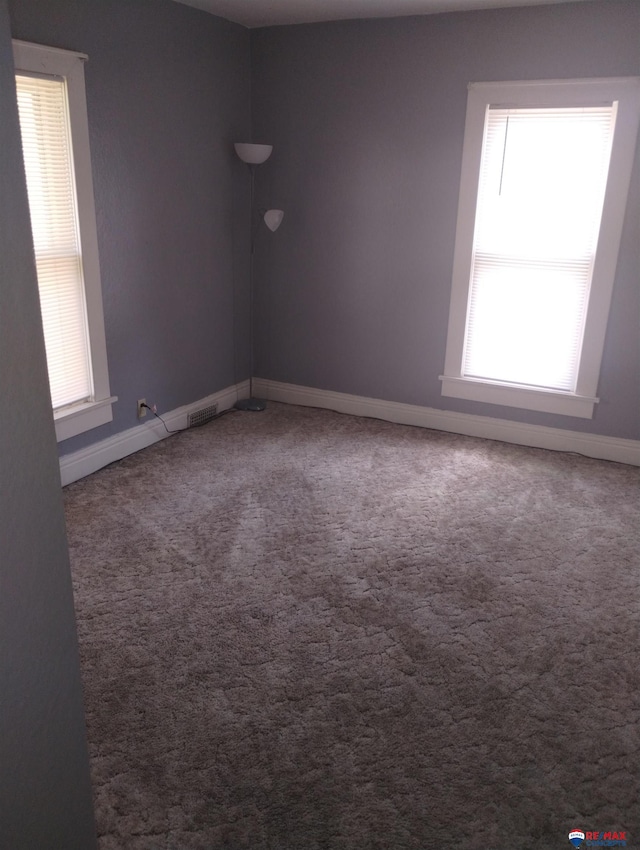 803 6th St, Fairbury, NE 68352 - spare room featuring baseboards and carpet flooring