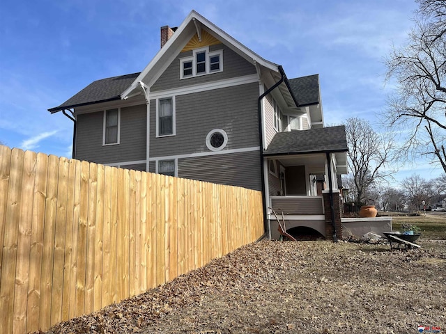 803 6th St, Fairbury, NE 68352 - view of side of home with a chimney and roof with shingles