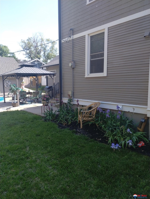 803 6th St, Fairbury, NE 68352 - view of side of property with a gazebo, a yard, and a patio