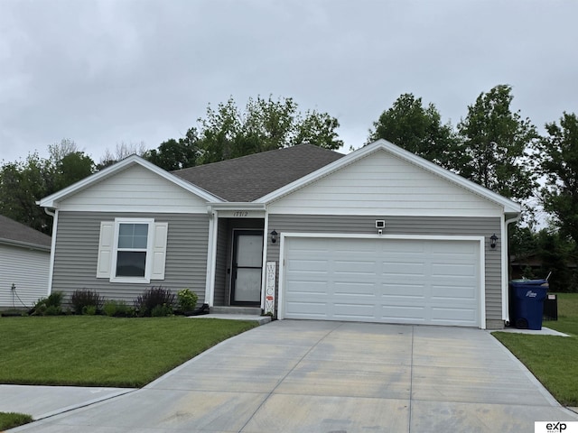 ranch-style house featuring driveway, an attached garage, and a front lawn