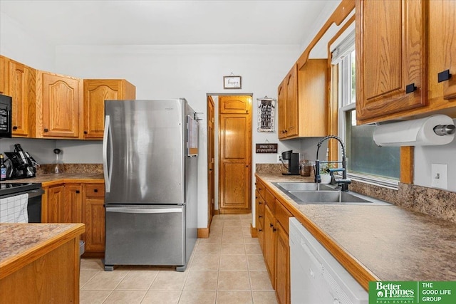 4188 Chicago St, Omaha, NE 68131 - kitchen featuring black appliances, a sink, brown cabinets, and light tile patterned floors