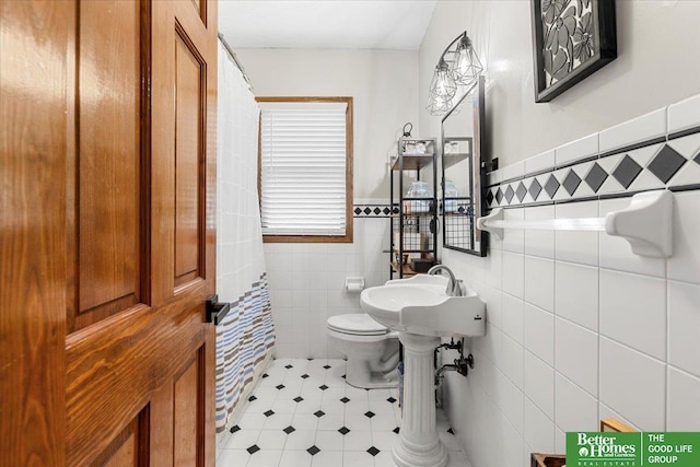 4188 Chicago St, Omaha, NE 68131 - bathroom featuring tile walls, toilet, a wainscoted wall, and curtained shower