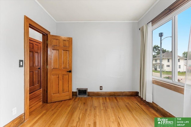 4188 Chicago St, Omaha, NE 68131 - unfurnished room featuring ornamental molding, plenty of natural light, light wood-style floors, and baseboards