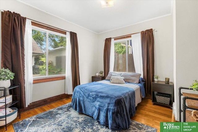 4188 Chicago St, Omaha, NE 68131 - bedroom with ornamental molding, multiple windows, wood finished floors, and baseboards