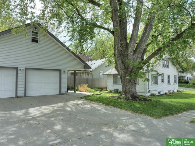 4188 Chicago St, Omaha, NE 68131 - view of front of property featuring a garage, central air condition unit, and driveway