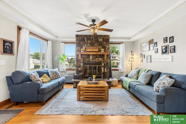 4188 Chicago St, Omaha, NE 68131 - living room featuring a tray ceiling, ceiling fan, wood finished floors, and a fireplace