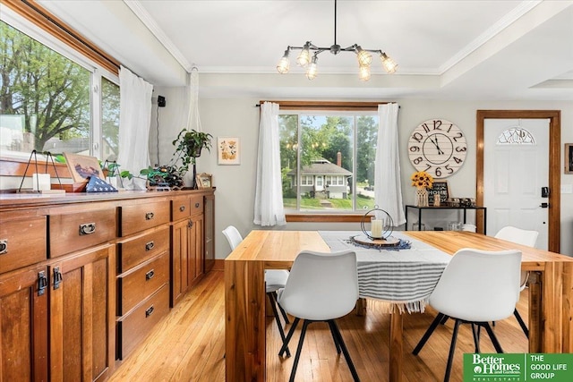 4188 Chicago St, Omaha, NE 68131 - dining area featuring a chandelier, light wood-style flooring, and crown molding