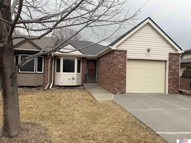 4932 High St, Lincoln, NE 68506 - ranch-style home with brick siding, concrete driveway, a shingled roof, an attached garage, and entry steps