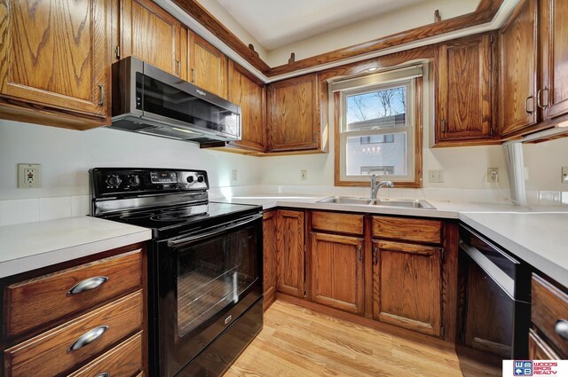 4932 High St, Lincoln, NE 68506 - kitchen with black electric range oven, stainless steel microwave, a sink, dishwasher, and brown cabinets