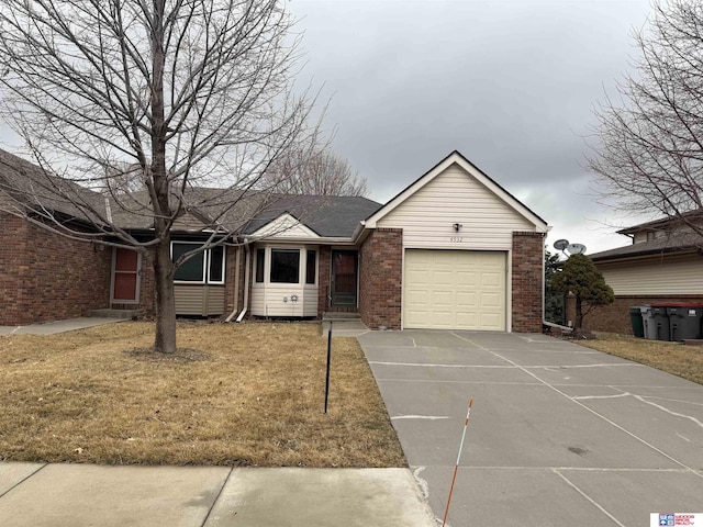 4932 High St, Lincoln, NE 68506 - ranch-style house with brick siding, concrete driveway, an attached garage, and a front lawn