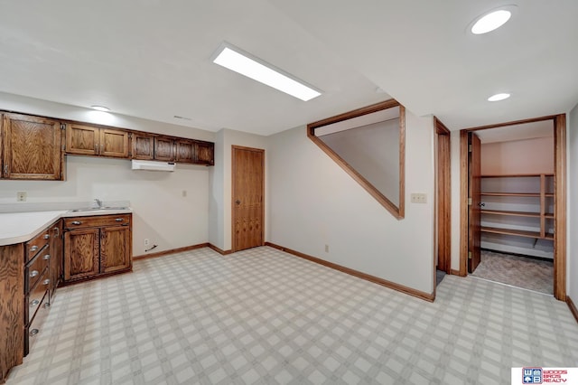 4932 High St, Lincoln, NE 68506 - kitchen with a sink, baseboards, light countertops, and light flooring