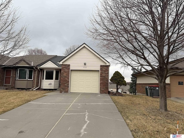 4932 High St, Lincoln, NE 68506 - ranch-style house featuring brick siding, a garage, driveway, and a front yard