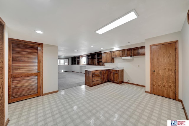4932 High St, Lincoln, NE 68506 - kitchen with baseboards, light countertops, open floor plan, a peninsula, and open shelves
