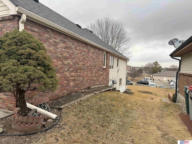 4932 High St, Lincoln, NE 68506 - view of property exterior featuring brick siding and roof with shingles