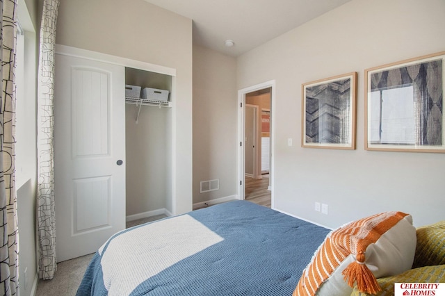 bedroom with carpet flooring, a closet, and baseboards