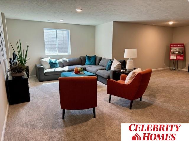 carpeted living area featuring a textured ceiling, baseboards, and recessed lighting
