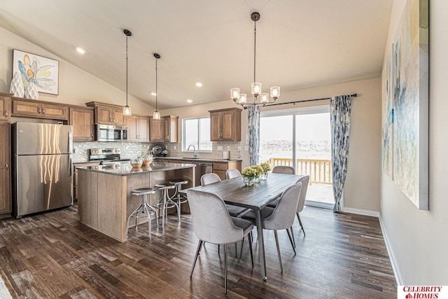 dining space featuring a chandelier, dark wood finished floors, vaulted ceiling, baseboards, and recessed lighting