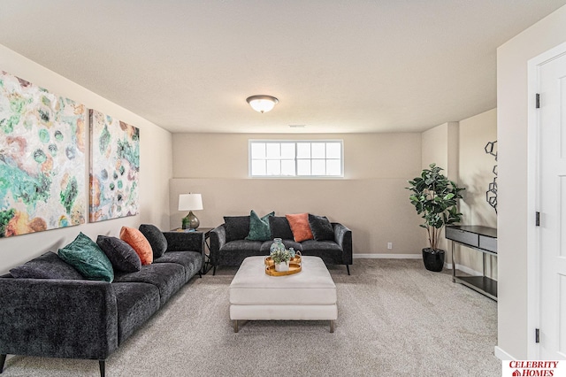 carpeted living area featuring baseboards