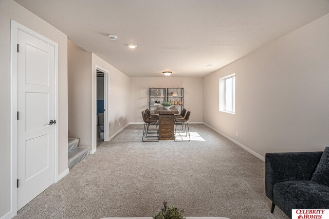 dining room featuring carpet and baseboards