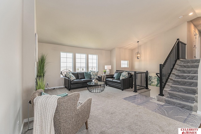 carpeted living area with vaulted ceiling, a chandelier, stairs, and baseboards