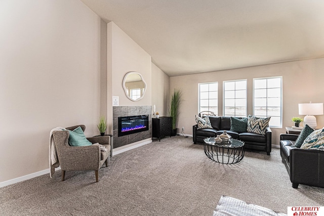 living area with carpet flooring, vaulted ceiling, a fireplace, and baseboards