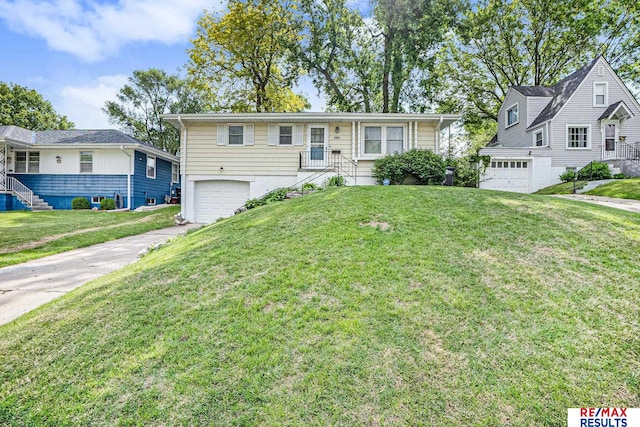 2137 S 49th St, Omaha, NE 68106 - view of front of house featuring a garage, driveway, and a front yard