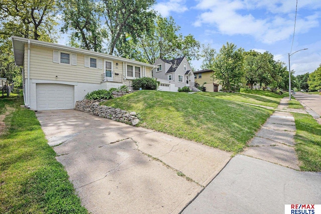 2137 S 49th St, Omaha, NE 68106 - view of front of property featuring a garage, driveway, and a front lawn