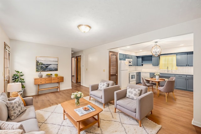 2137 S 49th St, Omaha, NE 68106 - living room featuring light wood-type flooring and a chandelier