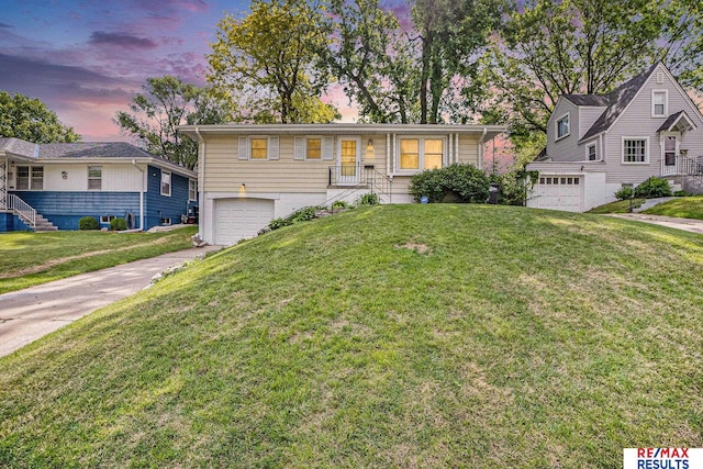 2137 S 49th St, Omaha, NE 68106 - single story home with an attached garage, concrete driveway, and a lawn