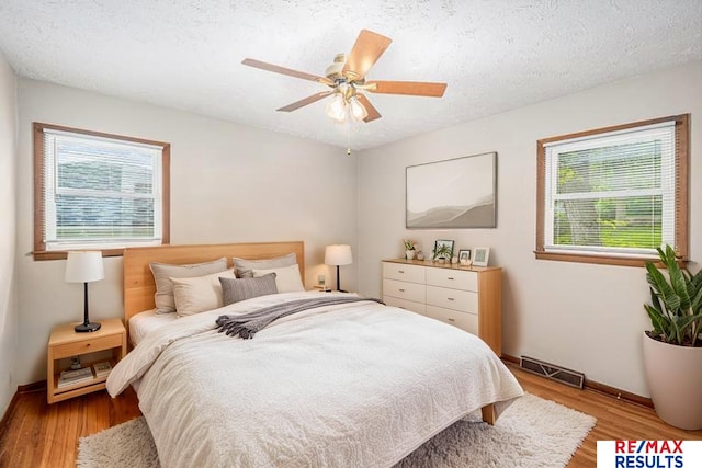 2137 S 49th St, Omaha, NE 68106 - bedroom featuring wood finished floors, baseboards, a ceiling fan, and a textured ceiling