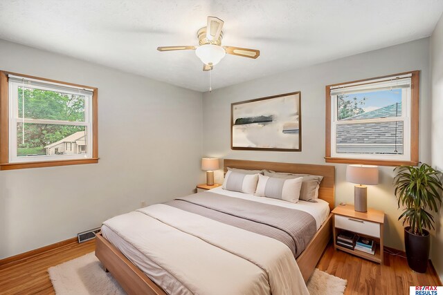 2137 S 49th St, Omaha, NE 68106 - bedroom with wood finished floors, baseboards, and ceiling fan