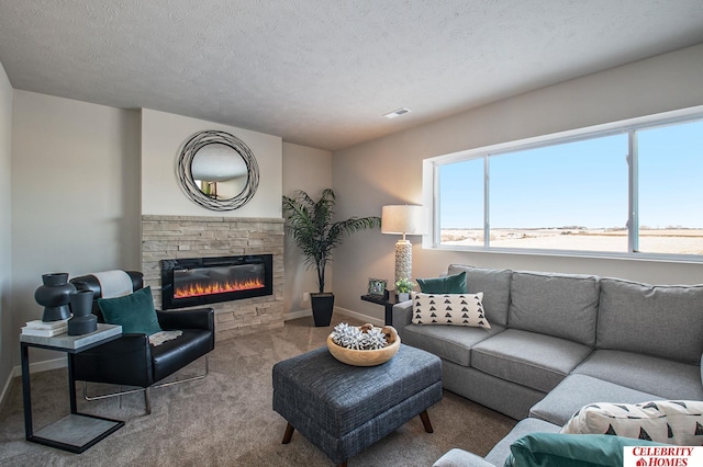carpeted living area with a stone fireplace, baseboards, and a textured ceiling