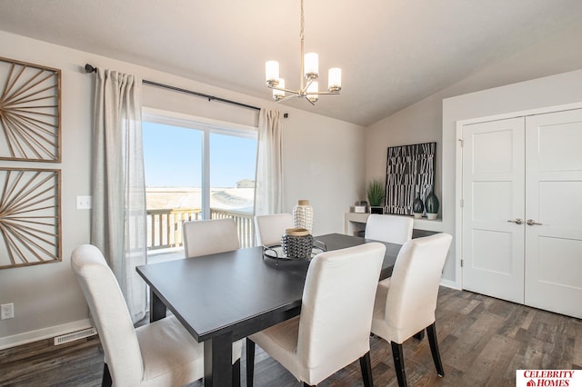 dining space featuring a chandelier, lofted ceiling, dark wood-style floors, and baseboards