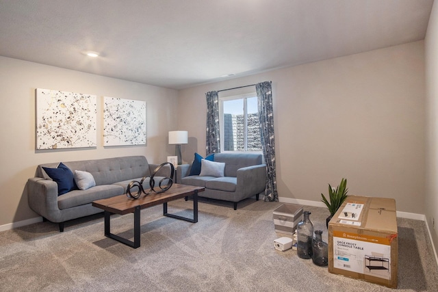living room featuring carpet flooring and baseboards