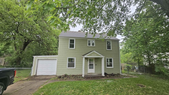 colonial home with concrete driveway and an attached garage