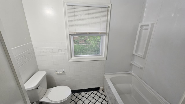 full bathroom with tile walls, toilet, a tub, tile patterned flooring, and a shower