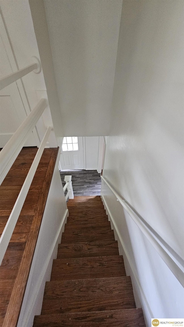 stairs featuring wood finished floors