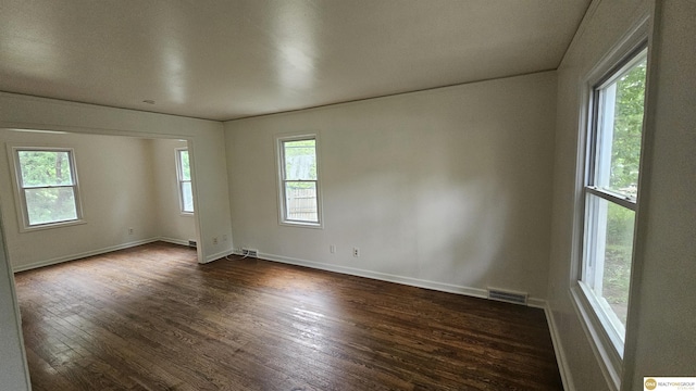 unfurnished room featuring dark wood finished floors and baseboards